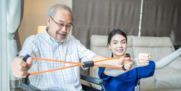 Senior Man Doing Resistance Training With the Guidance of a Female Nurse at Assisted Living Facility