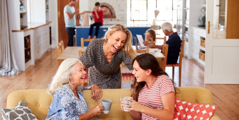 Elderly Woman Laughing with Daughter and Granddaughter at Assisted Living Facility